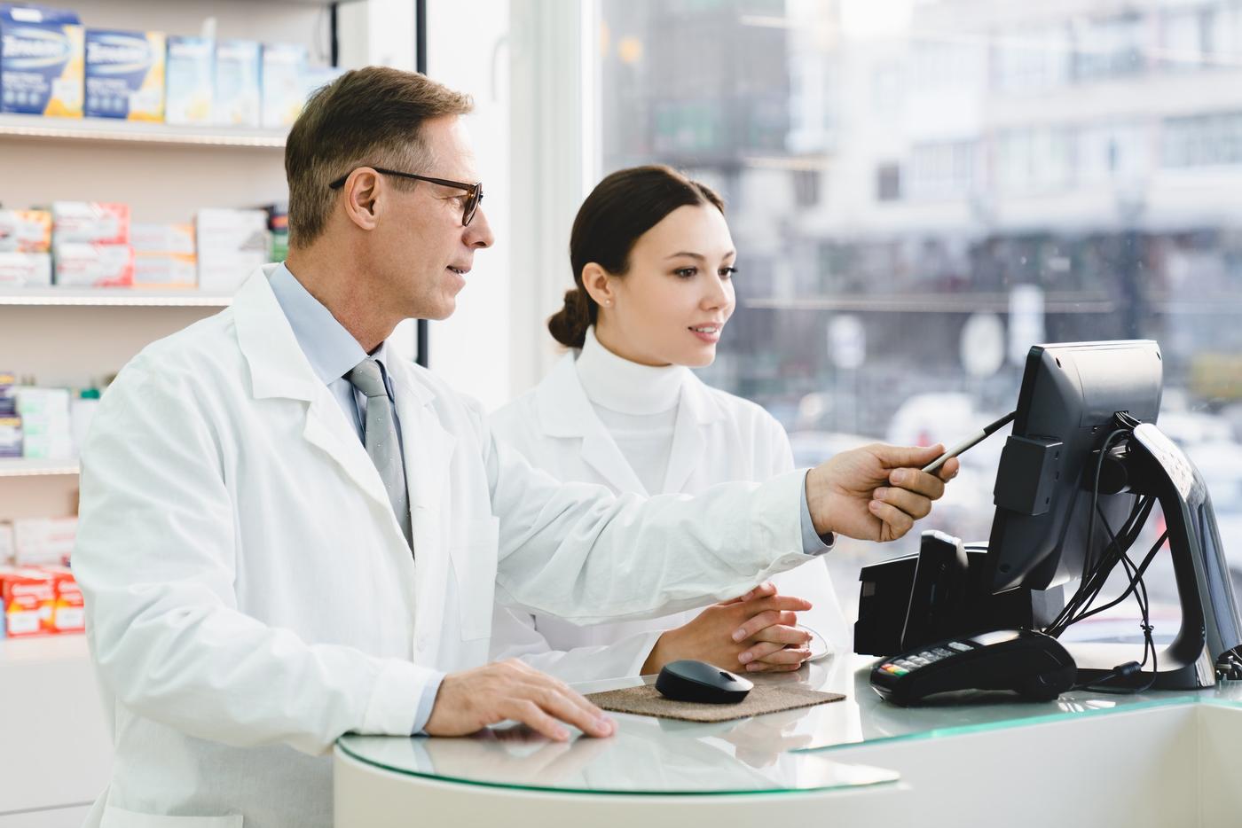 Pharmacist discussing medication with a colleague